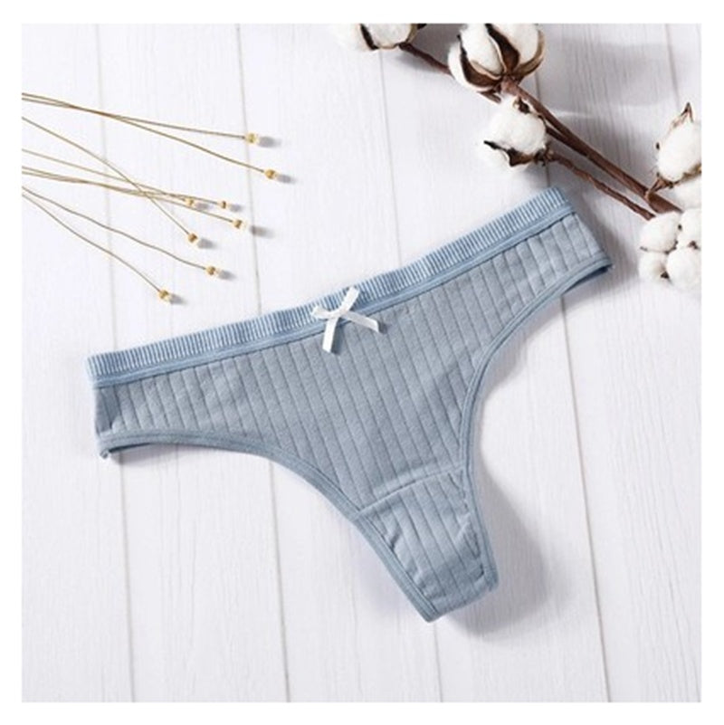 Women Panties in pink ribbed cotton with bow detail on a wooden background.
