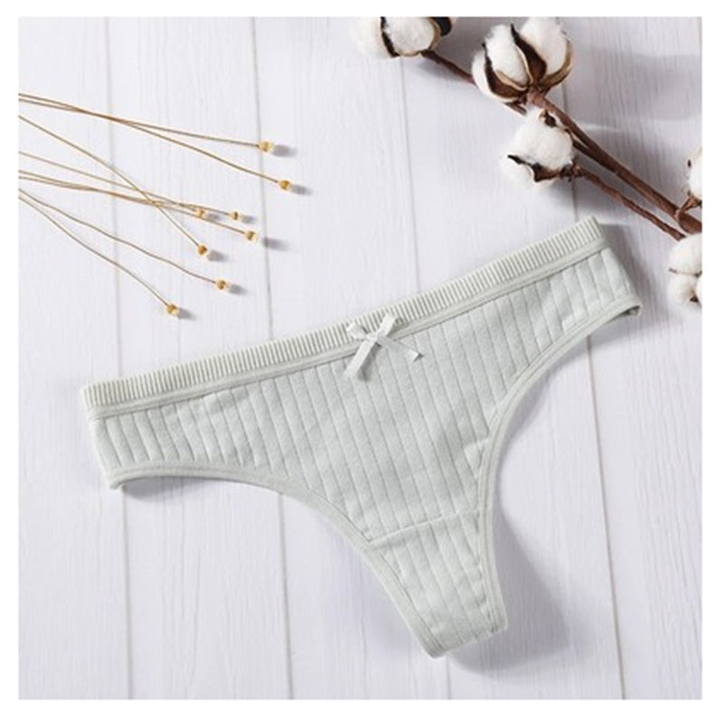  Women Panties in pink ribbed cotton with bow detail on a wooden background.