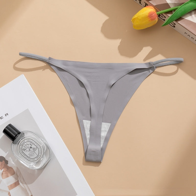  Seamless panties Ice Silk pant in beige color laid flat with a floral accent and a bottle of perfume.