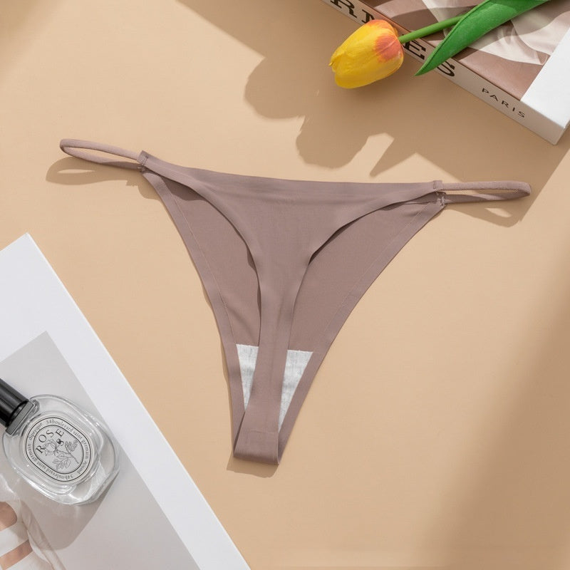  Seamless panties Ice Silk pant in beige color laid flat with a floral accent and a bottle of perfume.