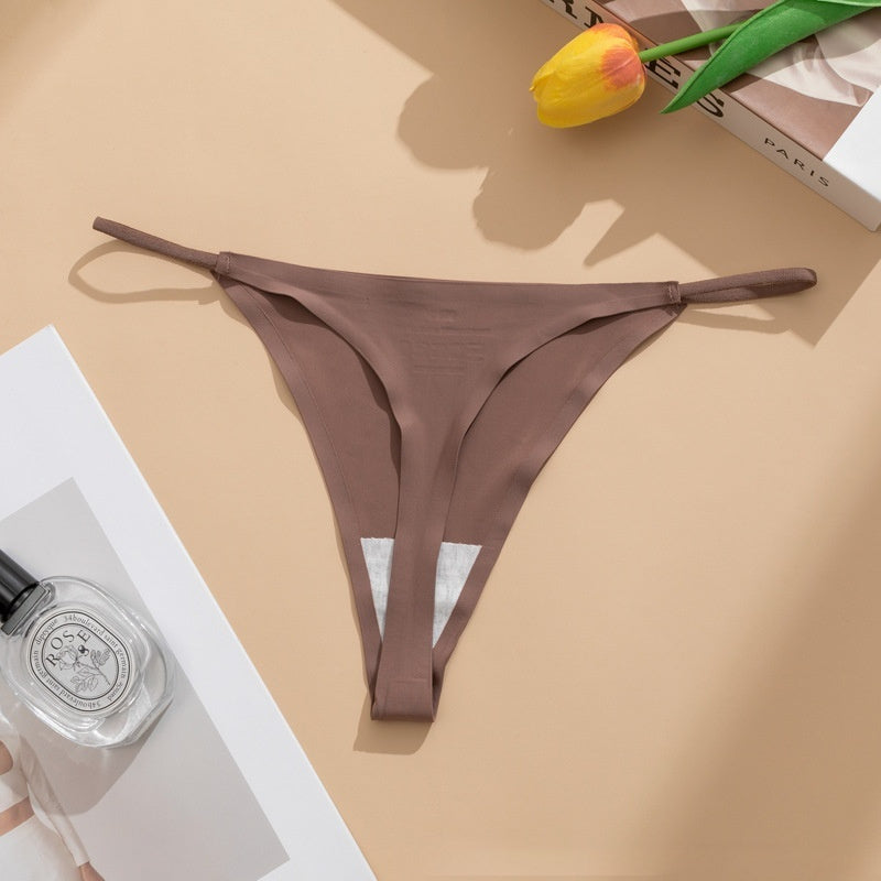  Seamless panties Ice Silk pant in beige color laid flat with a floral accent and a bottle of perfume.
