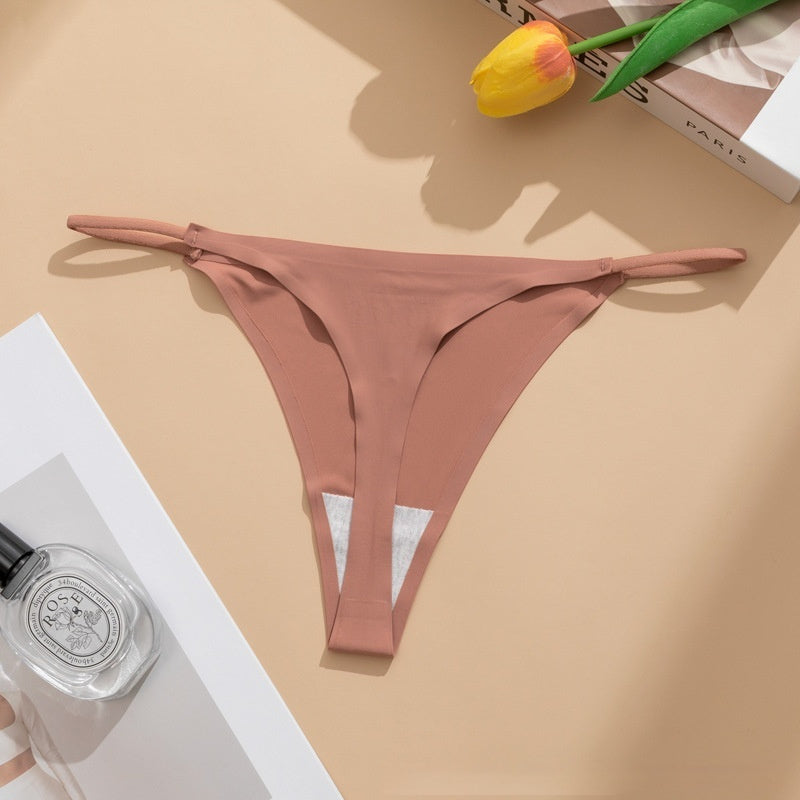  Seamless panties Ice Silk pant in beige color laid flat with a floral accent and a bottle of perfume.